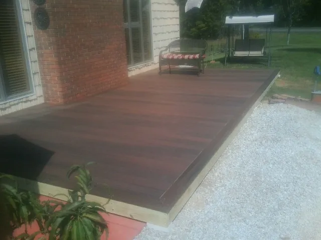 Freshly stained wood deck built against a brick home in Whittier
