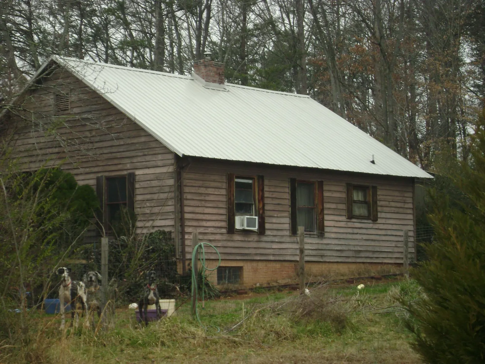 White metal roof on an old wood sided farmhouse, from a Metal Roof Installation job in Whittier